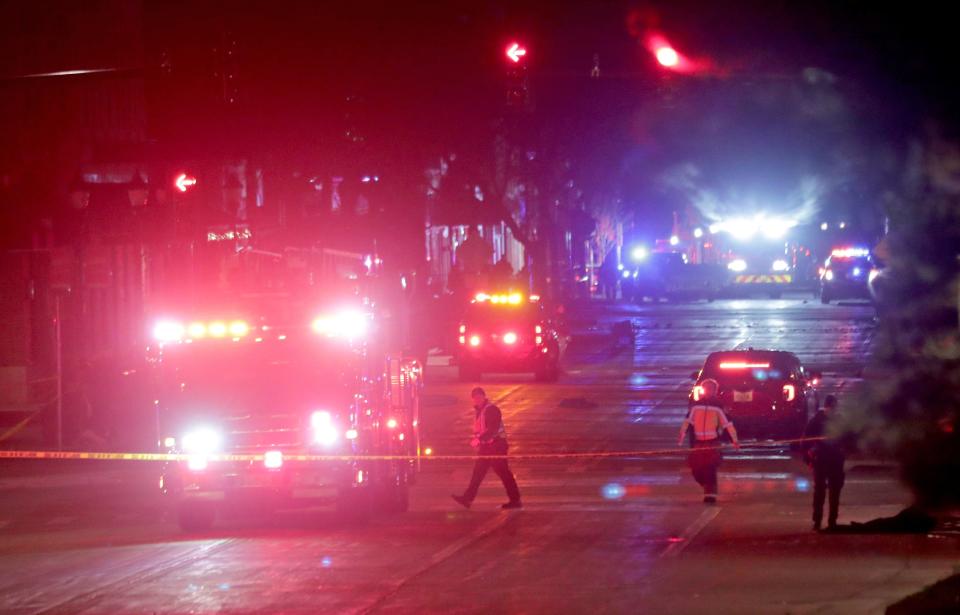 Police investigate at the scene of a crash involving multiple people at a holiday parade in Waukesha, Wisconsin. Authorities said late Sunday that at least 20 people were injured in the incident.