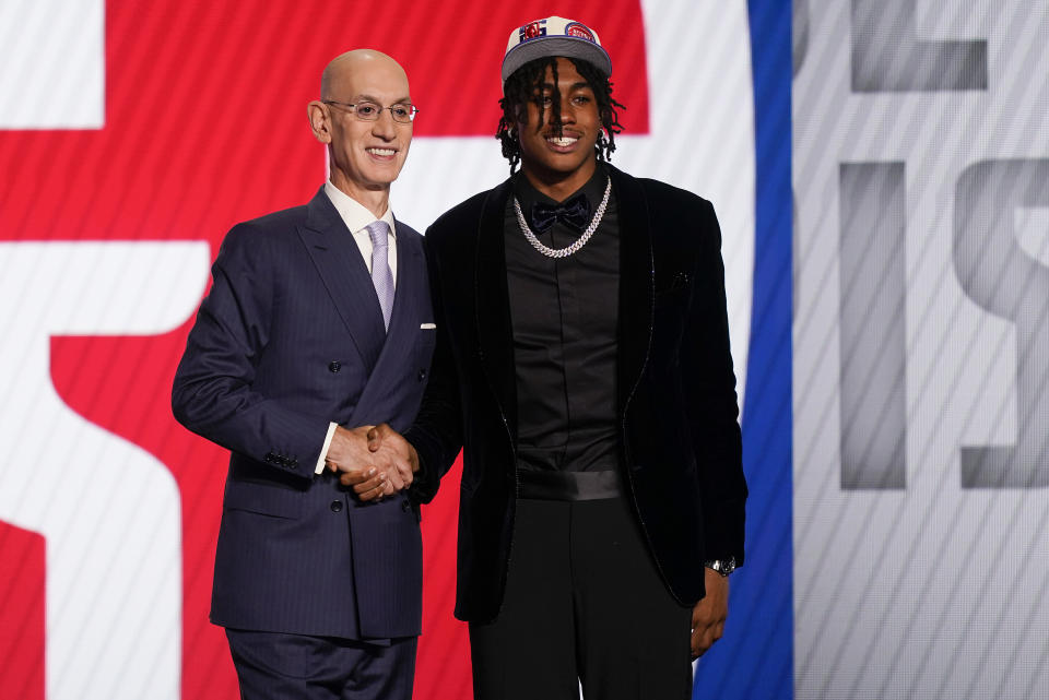 Jaden Ivey, right, shakes hands with NBA Commissioner Adam Silver after being selected fifth overall by the Detroit Pistons in the NBA basketball draft, Thursday, June 23, 2022, in New York. (AP Photo/John Minchillo)