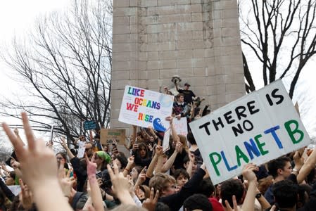 Students hold placards during a demonstration against climate change at Columbus Circle in New York