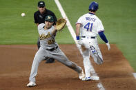 Texas Rangers' Eli White (41) reaches first base ahead of the throw to Oakland Athletics first baseman Matt Olson on an infield hit in the fourth inning of a baseball game Thursday, June 24, 2021, in Arlington, Texas. (AP Photo/Louis DeLuca)