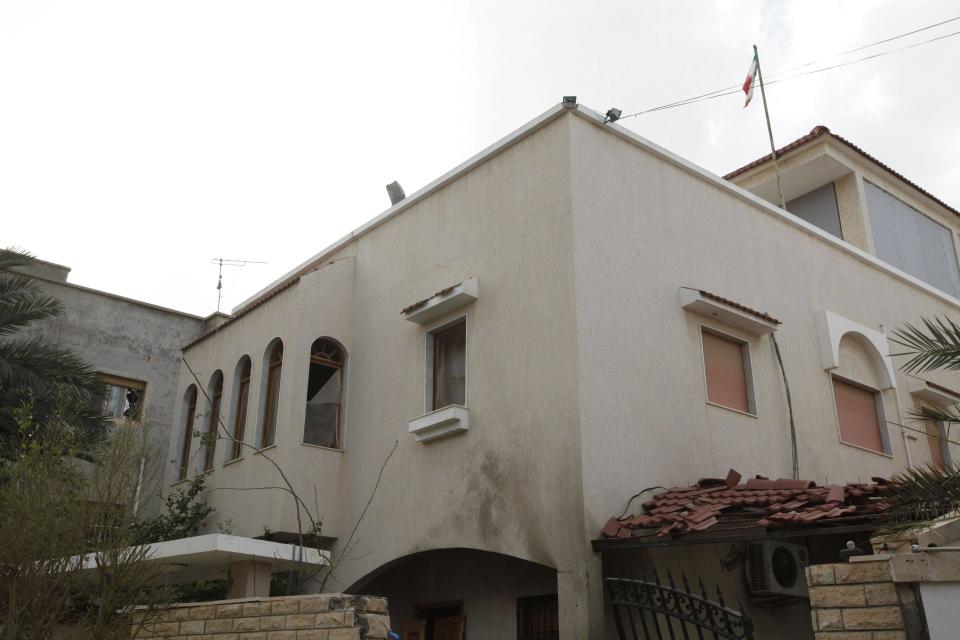 A general view of the damage caused by a bomb blast is seen at the gate of the Iranian ambassador's residence in Tripoli