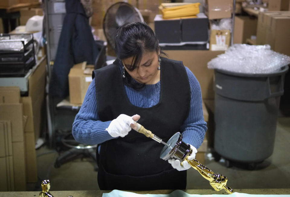 CHICAGO, IL - FEBRUARY 09: Josefina Govea assembles an Oscar statuette at R.S. Owens & Company February 9, 2012 in Chicago, Illinois. R.S. Owens manufactures the Oscar statuettes which are presented at the annual Academy Awards by the Academy of Motion Picture Arts and Sciences. After the theft of the statuettes prior to the 2000 Academy Awards the company began casting the statuettes one year in advance of the show. (Photo by Scott Olson/Getty Images)