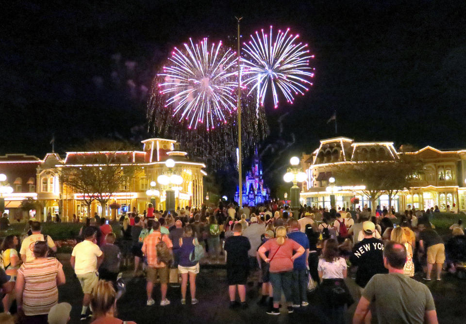 Guests gather on Main Street USA, in the Magic Kingdom at Walt Disney World, to watch fireworks before the park closed, Sunday night, March 15, 2020, in Lake Buena Vista, Fla. Walt Disney World announced that all their Florida parks will be closed for the rest of March as a result of the coronavirus pandemic. (Joe Burbank/Orlando Sentinel/Tribune News Service via Getty Images)