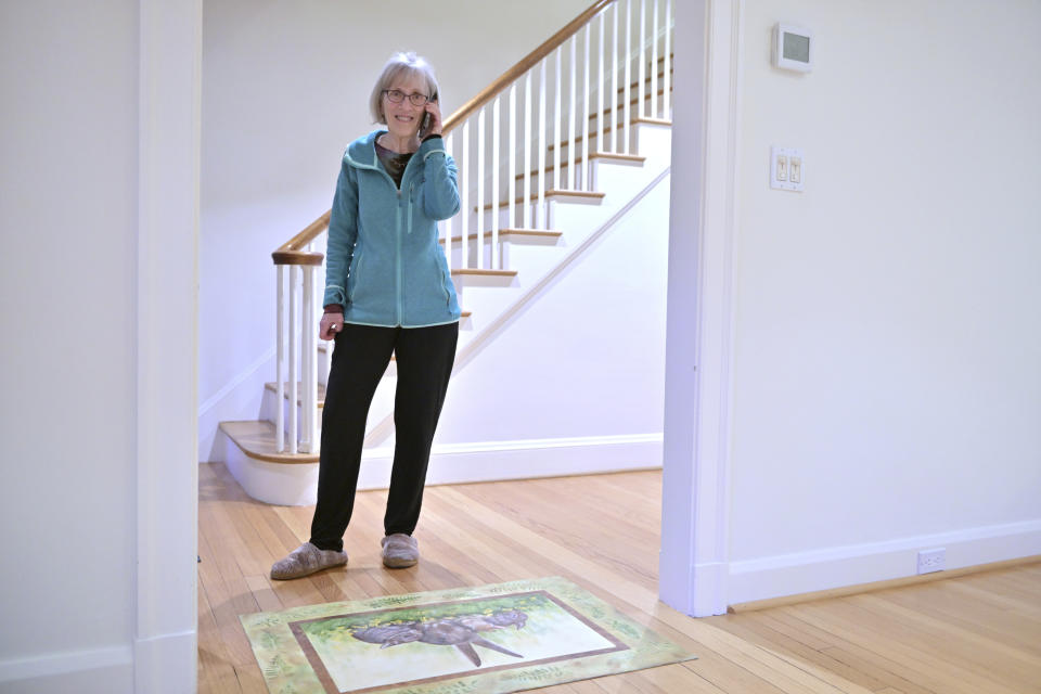 Claudia Goldin speaks to a reporter on the phone in her home in Cambridge, Mass. after learning that she received the Nobel Prize in Economics Monday, Oct. 9, 2023. The Nobel Prize in Economic Sciences has been awarded to Claudia Goldin for her work on the understanding of the gender gap in the labor market, it was announced on Monday, Oct. 9, 2023. (AP Photo/Josh Reynolds)