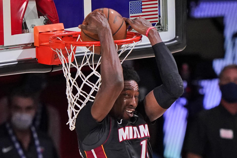 Miami Heat's Bam Adebayo (13) slams home a backward dunk during the second half of an NBA conference final playoff basketball game Sunday, Sept. 27, 2020, in Lake Buena Vista, Fla. (AP Photo/Mark J. Terrill)