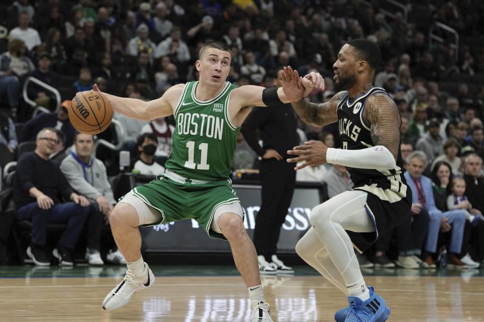 Boston Celtics' Payton Pritchard gets past Milwaukee Bucks' Damian Lillard during the first half of an NBA basketball game Tuesday, April 9, 2024, in Milwaukee. (AP Photo/Morry Gash)