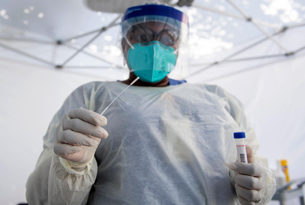 Image: A healthcare worker prepares to take a nasal swab sample at a Covid-19 testing site in Los Angeles in 2020. (Valerie Macon / AFP via Getty Images file)