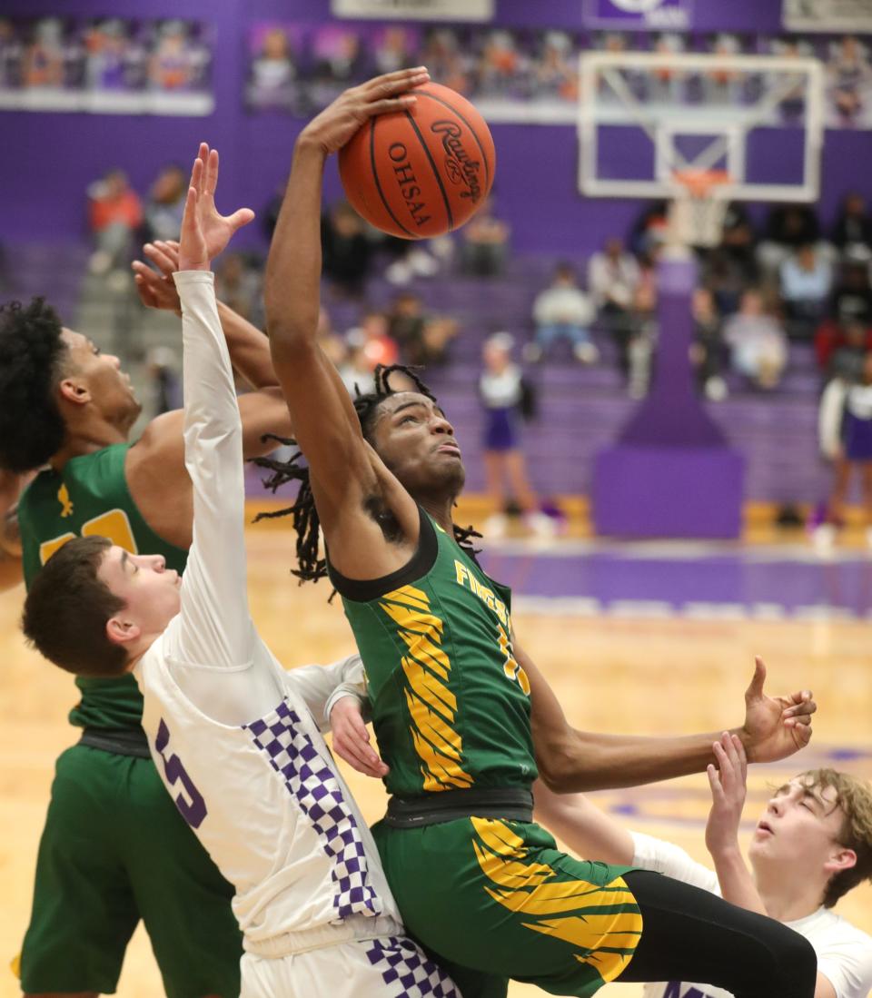 Firestone's Daniel Harper grabs a rebound in front of Barberton's Ben Huth during the Falcons' 50-48 win Wednesday night. [Phil Masturzo/Beacon Journal]