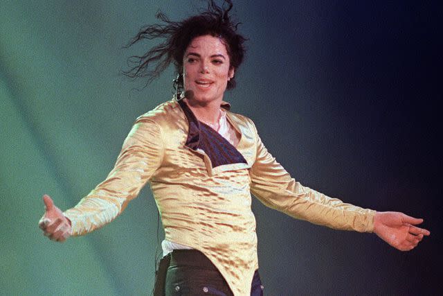 <p>FRANCIS Sylvain/AFP via Getty</p> Michael Jackson preforms before an estimated audience of 60,000 in Brunei on July 16, 1996.