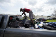 Bernie Murray rearranges luggage in Lake Charles, La., as he returns with eight family members in one truck, after evacuating from Hurricane Laura, Sunday, Aug. 30, 2020. (AP Photo/Gerald Herbert)