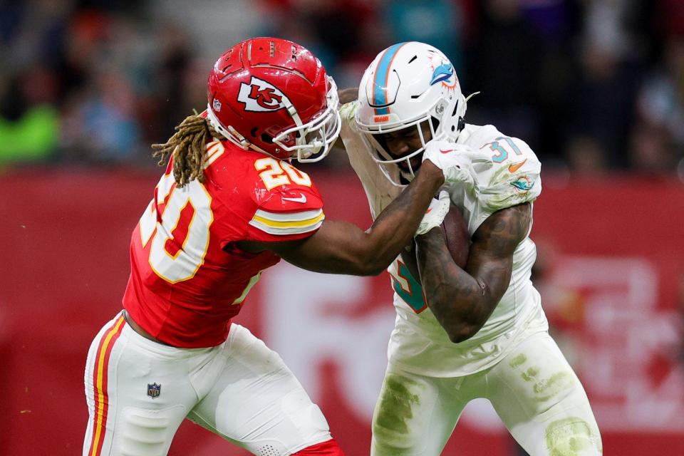 Miami Dolphins running back Raheem Mostert (31) holds off Kansas City Chiefs safety Justin Reid (20) in the fourth quarter during an NFL International Series game at Deutsche Bank Park.