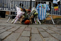 <p>An Argentinian national team jersey hangs at a memorial on West Street two days after a man driving a rented pickup truck mowed down pedestrians and cyclists on a bike path alongside the Hudson River, in New York City, Nov. 2, 2017. (Photo: Lucas Jackson/Reuters) </p>