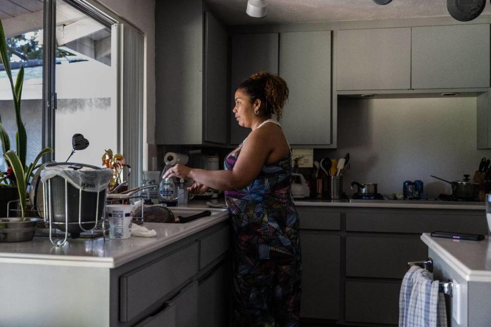 Margarita Yanez, who arrived last year in Sacramento with other migrants, washes dishes earlier this month.