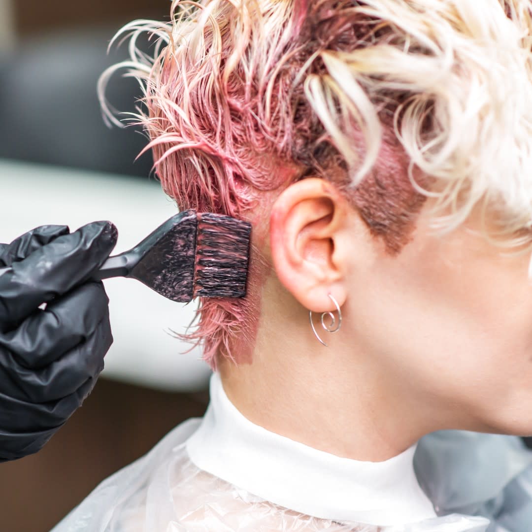  Woman getting her hair colored blonde with foil at los angeles salon. 