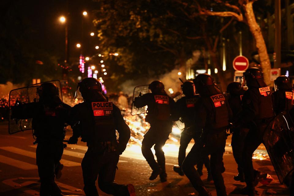 French riot police run during clashes with demonstrators at the Place de la Republique in Paris (REUTERS/Yara Nardi)