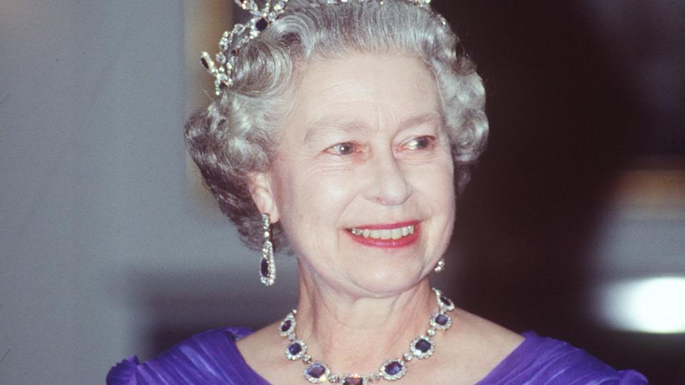 The late Queen wearing The King George Vi Victorian Suite Of Diamonds And Sapphires at a banquet on The Royal Yacht Britannia.