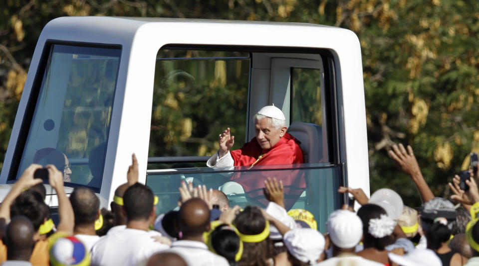 FILE - Pope Benedict XVI waves from his popemobile as he arrives in Revolution Square to celebrate a Mass in Havana, Cuba, on March 28, 2012. Pope Emeritus Benedict XVI, the German theologian who will be remembered as the first pope in 600 years to resign, has died, the Vatican announced Saturday. He was 95. (AP Photo/Javier Galeano, File)