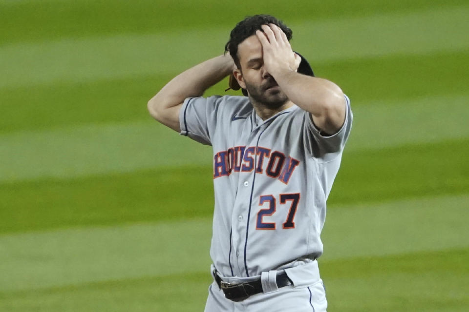 Houston Astros second baseman Jose Altuve wipes his forehead during a pause in the fifth inning of a baseball game against the Seattle Mariners, Wednesday, Sept. 23, 2020, in Seattle. (AP Photo/Ted S. Warren)