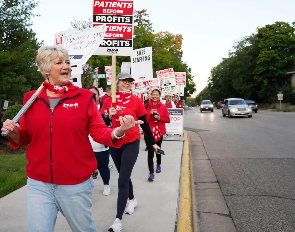 Mary Turner, president of the Minnesota Nurses Association, left, joins nurses striking Monday, Sept. 12, 2022, outside North Memorial Health Hospital in Robbinsdale, Minnesota for a three-day strike.