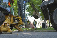 A Denver Water crew works to replace a lead water service line installed in 1927 with a new copper one at a private home on Thursday, June 17, 2021, in Denver. While President Joe Biden's infrastructure bill proposes $45 million for eliminating lead pipes and service lines, some utility companies and municipalities have already started replacing them. (AP Photo/Brittany Peterson)