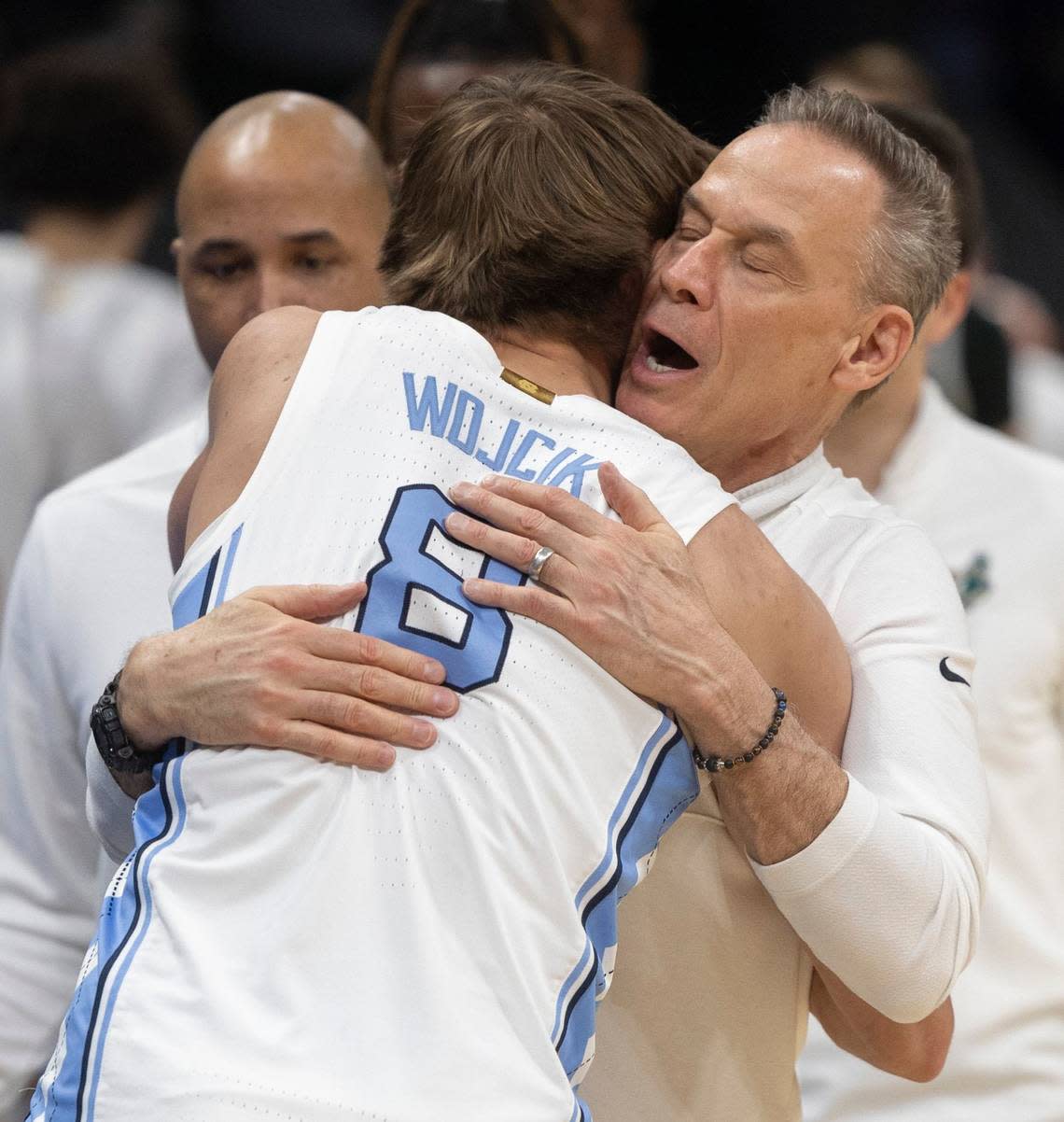 Michigan State assistant coach Doug Wojcik embraces his son Paxson Wojcik (8), a member of the North Carolina Tar Heels, following North Carolina’s 85-69 victory over Michigan State on Saturday, March 23, 2024, in the second round of the NCAA Tournament at Spectrum Center in Charlotte, N.C.