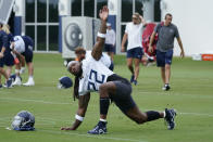 FILE - Tennessee Titans running back Derrick Henry (22) stretches during NFL football training camp July 27, 2022, in Nashville, Tenn. The NFL essentially is back to normal going into its third season dealing with COVID-19. All the protocols devised and tweaked by the league and the NFL Players Association that all 32 teams followed through 2020 and 2021 were suspended last March, with the NFL citing trends showing the spread of the coronavirus declining. (AP Photo/Mark Humphrey, File)