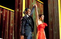 Hunger Games host Caesar Flickerman (Stanley Tucci) introduces newly-styled tribute Katniss Everdeen (Jennifer Lawrence) to the nation of Panem.