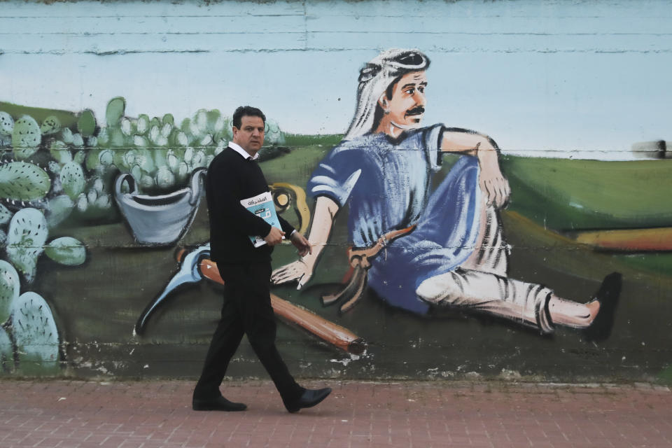 Ayman Odeh, Israeli Arab parliament member and leader of the Joint List alliance, walks during an election campaign event in then town of Yabeh, West Bank, Friday, Feb. 21, 2020. (AP Photo/Mahmoud Illean)