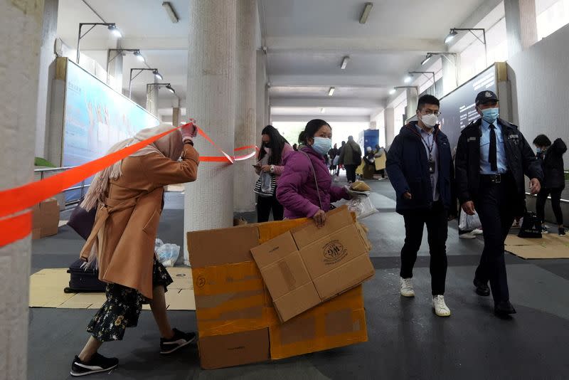 FILE PHOTO: Police officers disperse domestic workers gathering on their rest day, during the coronavirus disease (COVID-19) outbreak in Hong Kong, China