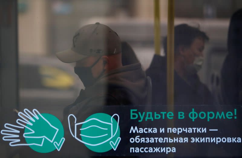 Passengers wear protective face masks in a bus amid the outbreak of the coronavirus disease in Moscow