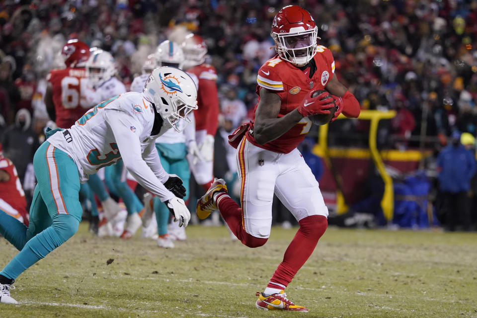 Kansas City Chiefs wide receiver Rashee Rice, right, runs against Miami Dolphins cornerback Ethan Bonner during the first half of an NFL wild-card playoff football game Saturday, Jan. 13, 2024, in Kansas City, Mo. (AP Photo/Ed Zurga)