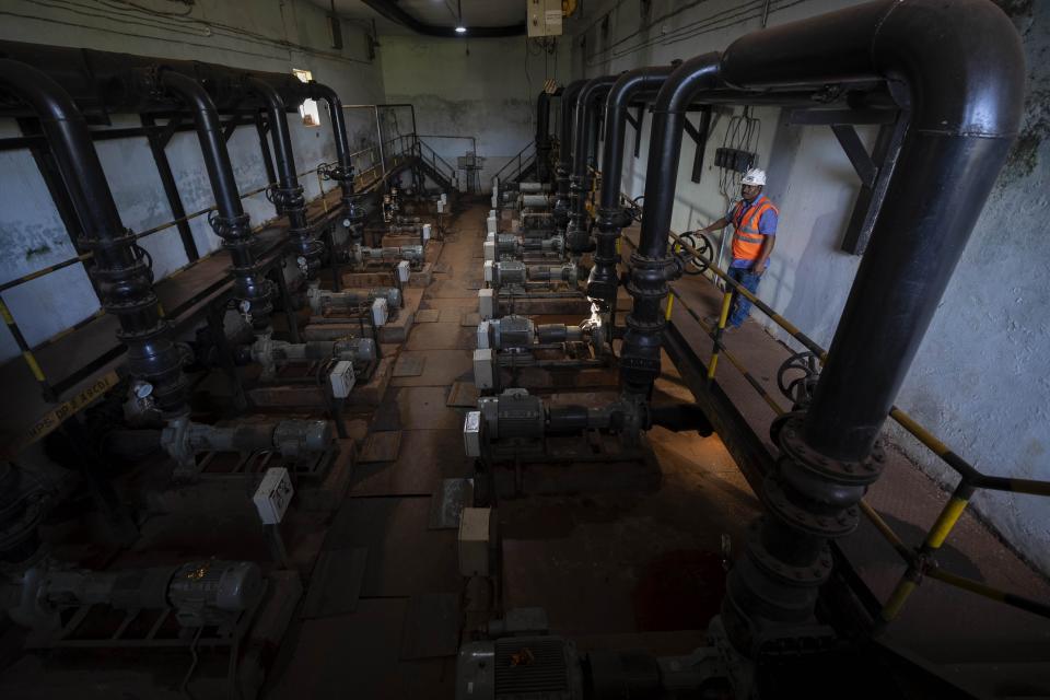 A mining engineer shows how they filter water at a chromium mine near Kaliapani village in Jajpur district, Odisha, India on July 5, 2023. Chromium, used mostly as a coating to stop rust in steel and car parts, has been deemed necessary for India's transition to cleaner energy. (AP Photo/Anupam Nath)