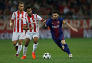 Soccer Football - Champions League - Olympiacos vs FC Barcelona - Karaiskakis Stadium, Piraeus, Greece - October 31, 2017 Barcelona’s Lionel Messi in action with Olympiacos' Alaixys Romao REUTERS/Alkis Konstantinidis