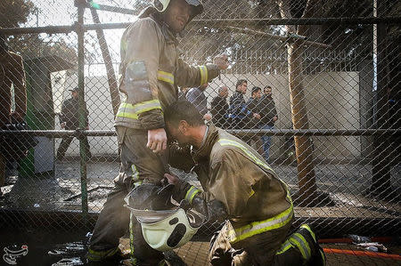 A firefighter reacts at the site of a blazing high-rise building in Tehran, Iran January 19, 2017. Tasnim News Agency/Handout via REUTERS