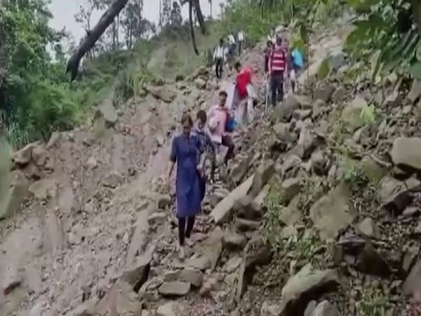 Alipurduar DM, health officials trek more than 10 kms to remote village in West Bengal for conducting COVID-19 vaccination drive on Sunday. [Photo/ANI]