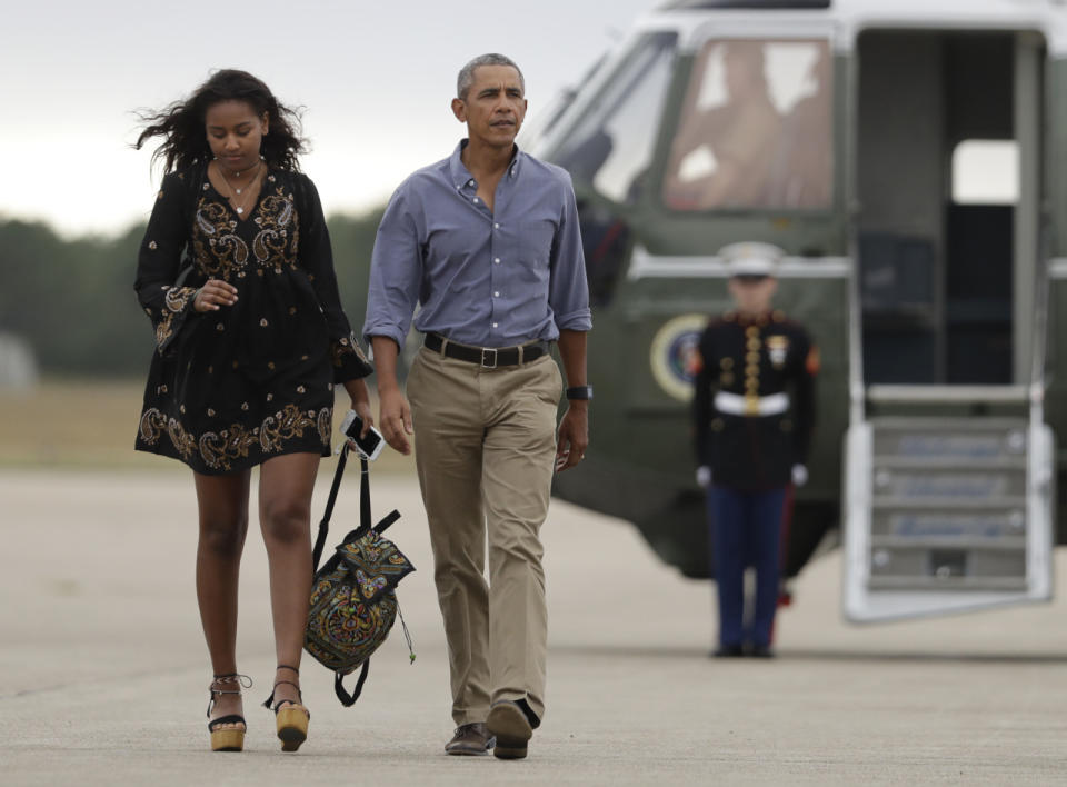 President Barack Obama and his daughter Sasha walk on the tarmac to board Air Force One at Air Station Cape Cod in Mass., Sunday, Aug. 21, 2016. Photo: AP