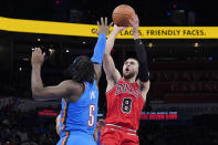 Chicago Bulls guard Zach LaVine (8) shoots over Oklahoma City Thunder forward Luguentz Dort (5) in the second half of an NBA basketball game Monday, Jan. 24, 2022, in Oklahoma City. (AP Photo/Sue Ogrocki)