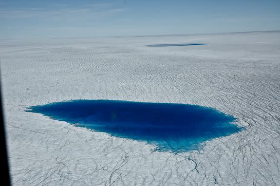 Dark meltwater on Greenland's surface.