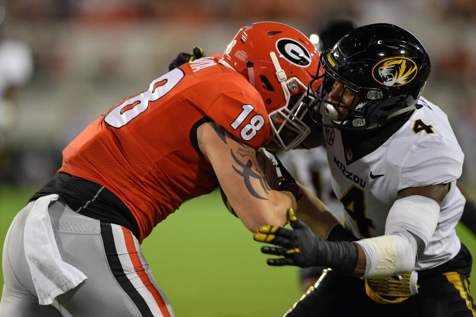 Georgia tight end Isaac Nauta (18) is tackled by Missouri linebacker Brandon Lee (4) during a game Oct. 14, 2017, at Sanford Stadium in Athens, Ga.