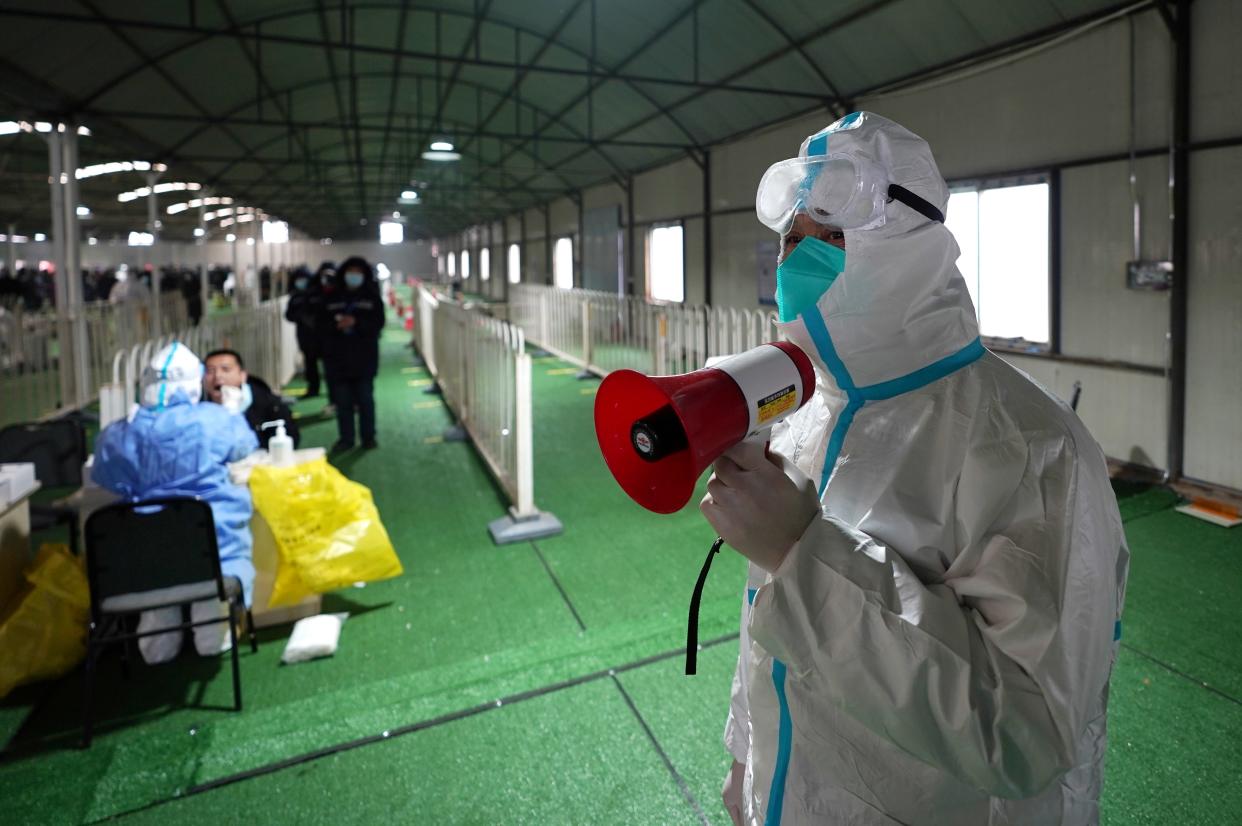 BEIJING, Jan. 26, 2021 -- A volenteer guides residents at a COVID-19 testing site in Daxing District of Beijing, capital of China, Jan. 26, 2021. Beijing started a second round of mass nucleic acid testing in Daxing District on Tuesday, in an effort to contain the latest COVID-19 resurgence. (Photo by Ju Huanzong/Xinhua via Getty) (Xinhua/Ju Huanzong via Getty Images)