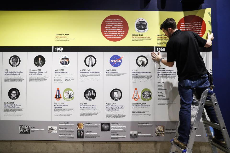 A workman prepares a display at the Armstrong Air & Space Museum, Wednesday, June 26, 2019, in Wapakoneta, Ohio. Very down to earth about most things, folks in this small western Ohio city are over the moon as they get ready to celebrate the 50th anniversary of the day they watched their hometown hero along with the world. Neil Armstrong put Wapakoneta on the map in July 1969 when he became the first human to walk on the moon. (AP Photo/John Minchillo)