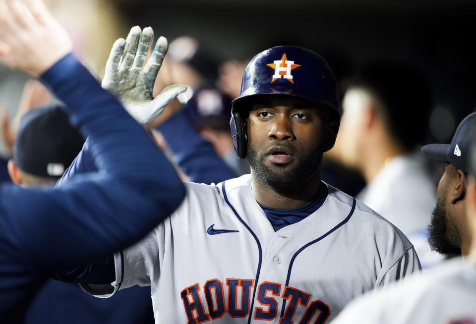 Houston Astros' Yordan Alvarez is greeted in the dugout after hitting a three-run home run against the Seattle Mariners during the third inning of a baseball game Friday, May 5, 2023, in Seattle. (AP Photo/Lindsey Wasson)