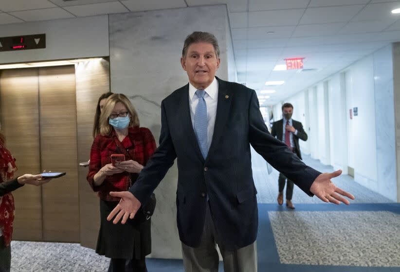 In this Dec. 13, 2021, photo, Sen. Joe Manchin, D-W.Va., leaves his office after speaking with President Joe Biden about his long-stalled domestic agenda, at the Capitol in Washington. Manchin's reluctance to endorse the Biden administration's expanded child tax credit program is rippling through his home state of West Virginia. Manchin, a moderate Democrat, is one of the last holdouts delaying passage of President Joe Biden's massive social and environmental package. (AP Photo/J. Scott Applewhite)