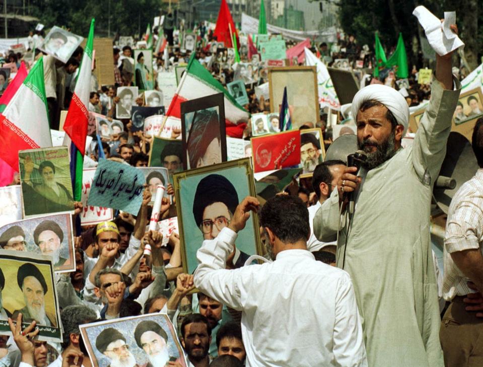 FILE - In this July 14, 1999 file photo, one of many Muslim hard-line clerics leads tens of thousands of people during a rally outside Tehran University. The demonstrations that erupted after Iran admitted to accidentally shooting down a Ukrainian jetliner early Wednesday, Jan. 8, 2020, during a tense standoff with the United States, are the latest of several waves of protest going back to the 1979 Islamic Revolution — all of which have been violently suppressed. (AP Photo/Kamran Jebreili, File)