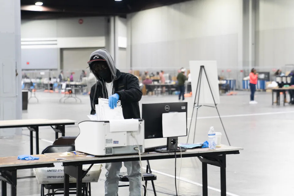 Election officials count votes for Fulton County, Ga.