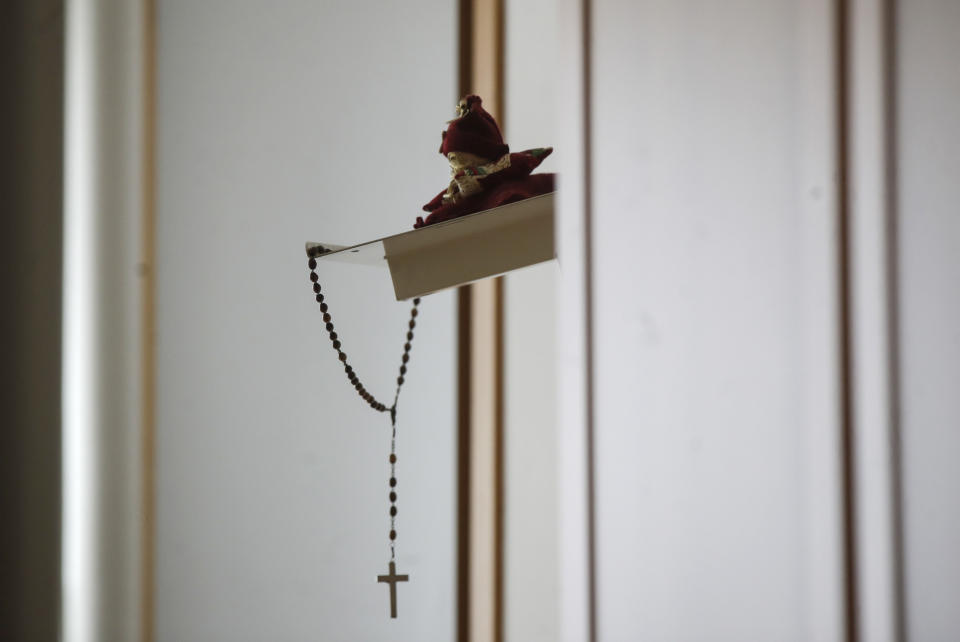 A crucifix hangs in a room of one of the hosts of the Martino Zanchi nursing home, in Alzano Lombardo, one of the area that most suffered the first wave of COVID-19, in Northern Italy, Saturday, Dec. 19, 2020. The holiday spirit is descending on the Zanchi nursing home in Alzano Lombardo, none of the first in Italy to have shut its doors to visitors after coronavirus was confirmed in the nearby hospital on Feb. 23, as the Bergamo province became the epicenter of Italy's deadly spring surge. (AP Photo/Luca Burno)