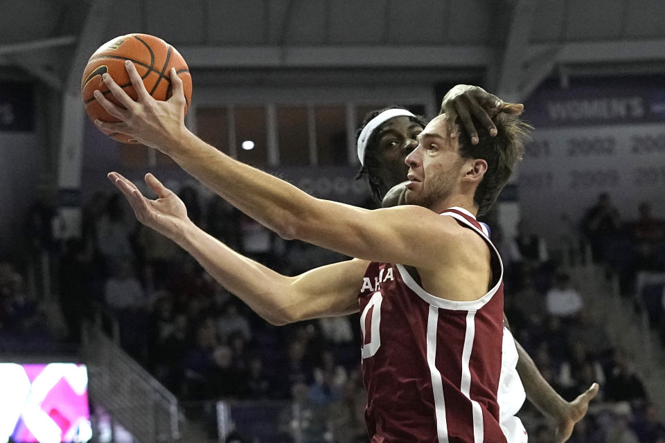 Oklahoma guard Le'Tre Darthard (0) drives past TCU forward Emanuel Miller during the first half of an NCAA college basketball game in Fort Worth, Texas, Wednesday, Jan. 10, 2024. (AP Photo/LM Otero)