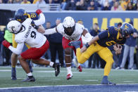 West Virginia quarterback Garrett Greene, right, scores a touchdown on a quarterback keeper during the first half of an NCAA college football game against Cincinnati, Saturday, Nov. 18, 2023, in Morgantown, W.Va. (AP Photo/Chris Jackson)