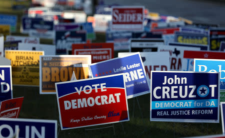 FILE PHOTO: Campaign signs are seen outside a polling station on the last day of early voting in Dallas, Texas, U.S., November 2, 2018. REUTERS/Mike Segar/File Photo