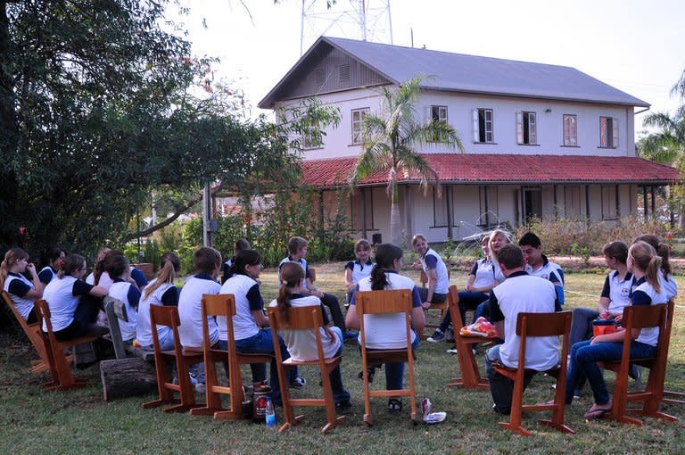 Mennonites students take part in a class outside the Mennonite museum in Filadelfia, Paraguay, on November 3, 2012. Mennonites this year celebrate the 85th anniversary of their first immagration to Paraguay from Russia and Germany